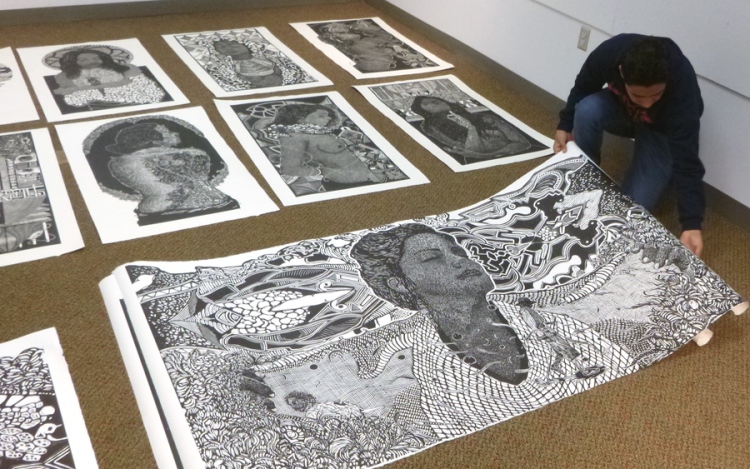 Alan Altamirano preparing his prints for display at Kutztown University. photo: K . McCloskey